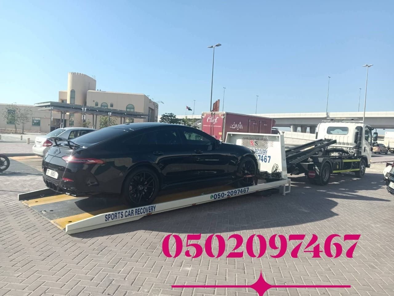 Ahmed Car Recovery flatbed truck loading a car in Dubai — professional damage-free recovery