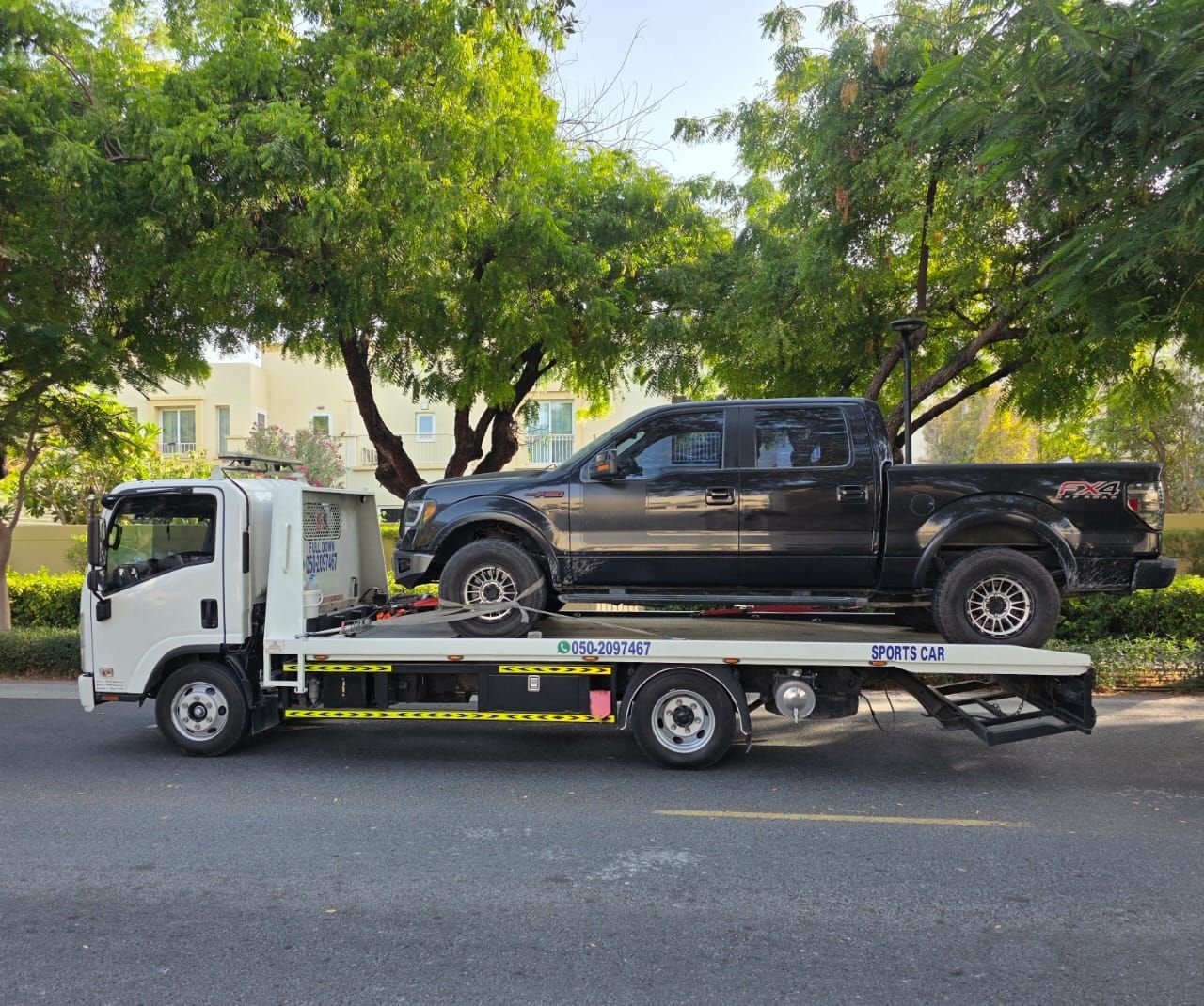 Vehicle on flatbed during car recovery in Dubai — Ahmed Car Recovery (job 01)