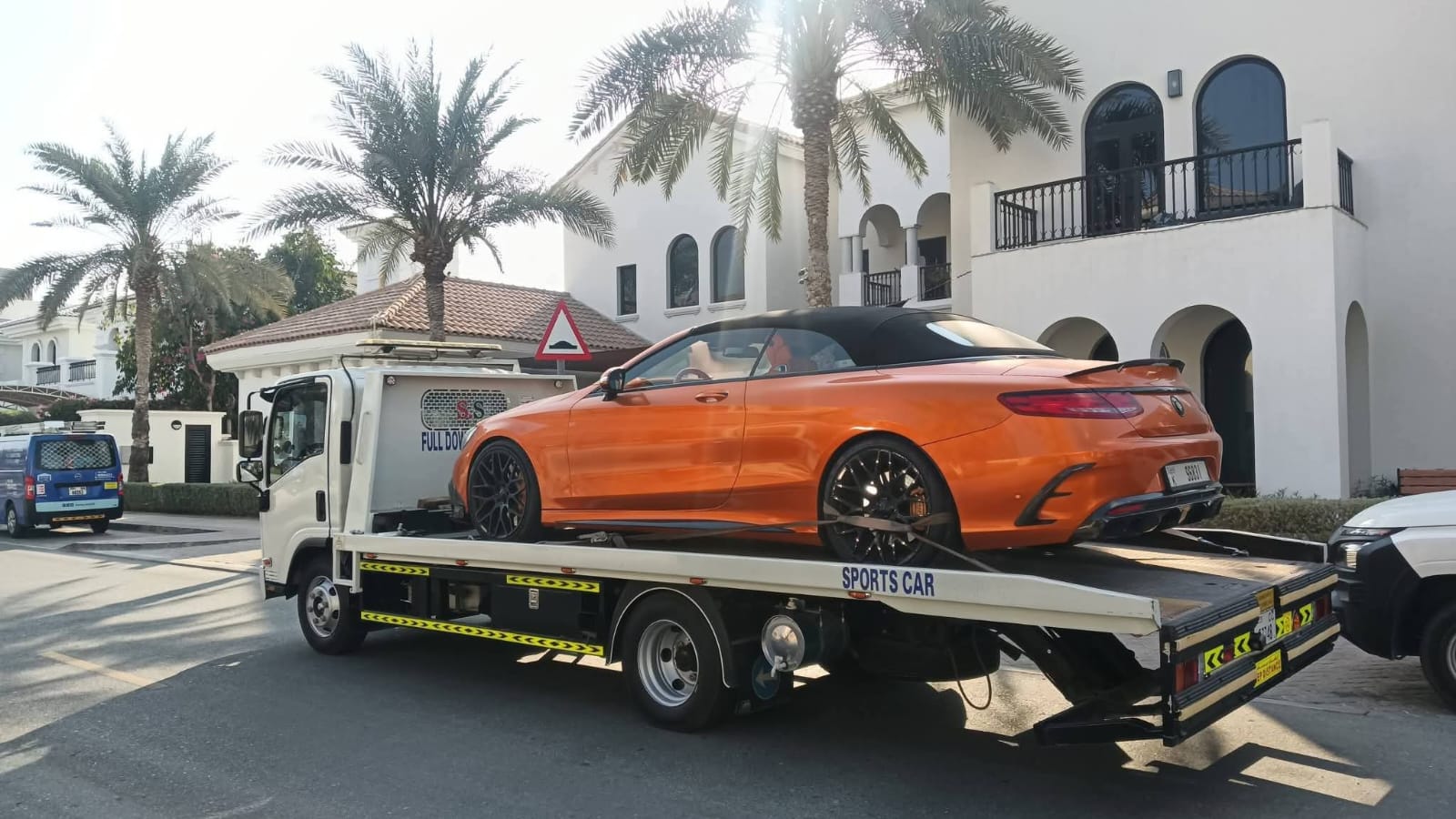 Luxury car recovery Dubai — Mercedes AMG convertible orange Palm